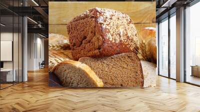 Bread from rye and wheat flour of rough grinding in wicker basket Wall mural