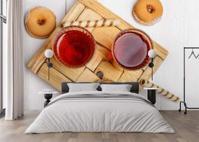 Two cups of hot tea with delicious cookies on white wooden table. Wall mural