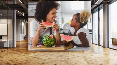 Beautiful African Mother and Daughter eating Watermelon at Home Kitchen Wall mural