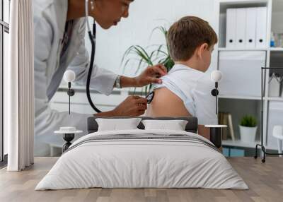 Doctor examining child with stethoscope. Respiratory disease diagnostics and treatment Wall mural