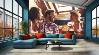 Happy friends having fun at bar - Young trendy people drinking beer and laughing together Wall mural