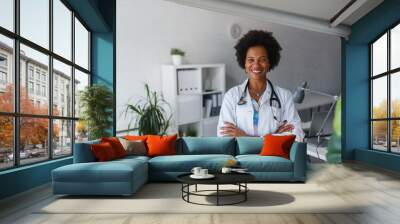 Portrait of female African American doctor standing in her office at clinic Wall mural