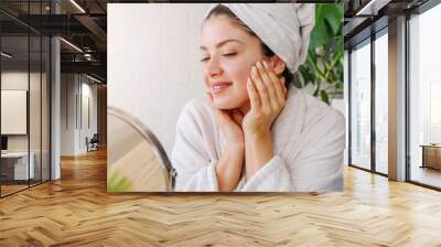 Portrait of young woman wearing bathrobe at home. Homemade natural cosmetics skin care routine. Wall mural