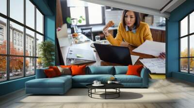 Young business entrepreneur woman working at home while having breakfast Wall mural