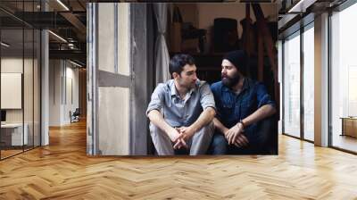 couple of young men talking on the stairs of an office Wall mural