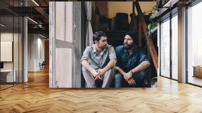 Couple of young men talking on the stairs of an office Wall mural