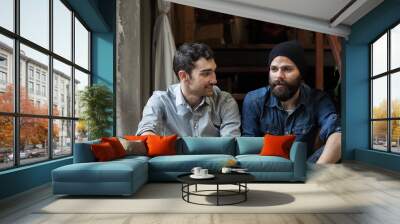 Couple of young men talking on the stairs of an office Wall mural