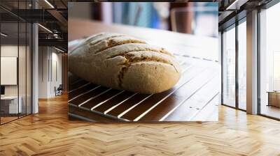 Freshly baked homemade wholemeal bread on a wooden table Wall mural