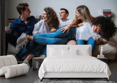 Portrait of a group of friends sitting on the sofa at home - Millennials have fun together in an apartment Wall mural