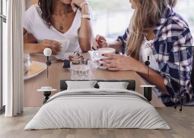 Two young and beautiful women meet at the bar for a cappuccino and to chat Wall mural