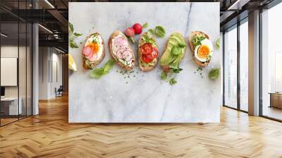 Breakfast sandwich bread with avocado, egg, radishes and tomatoes. Bruschetta or healthy snack ideas Wall mural