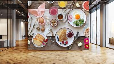 Easter festive breakfast or brunch set served on rustic wooden table. Overhead view, copy space Wall mural