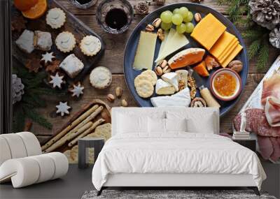 Festive winter appetizers table with various of cheese, curred meat, sweets, nuts and fruits. Festive family or party snack concept. Overhead view. Wall mural