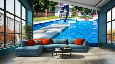 Selective focus on a swimming board as a young boy jumps into a pool.  Wall mural