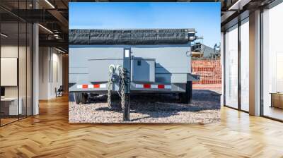 Selective focus on parked flat bed utility trailer with sides  Wall mural