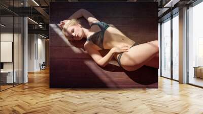 Sexy young woman in underwear posing on floor Wall mural