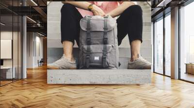 A man sitting with a backpack Wall mural