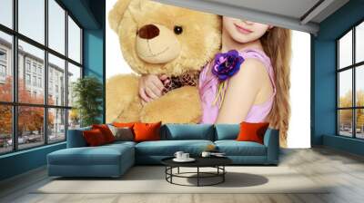 Beautiful little girl 5-6 years.She is holding a large teddy bea Wall mural