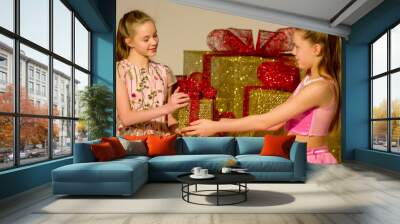 Cute Twin Sisters Exchanging Gifts, Christmas and New Year Holid Wall mural