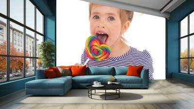 little girl licking a lollipop. Wall mural