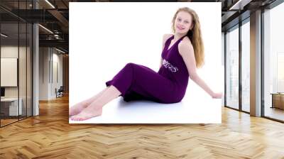 Teen girl posing on the floor in the studio. The concept of styl Wall mural