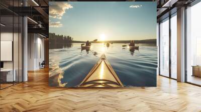 Calm lake with sunlight reflecting, people in kayaks enjoying outdoor adventure on peaceful waters. Wall mural