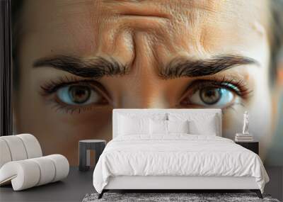 Close-up photo of a person's face with a wrinkled forehead, expression showing concern or concentration. Wall mural