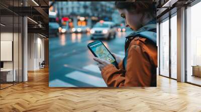 Man navigating urban streets on smartphone, utilizing smart city technology for efficient travel and exploration. Wall mural