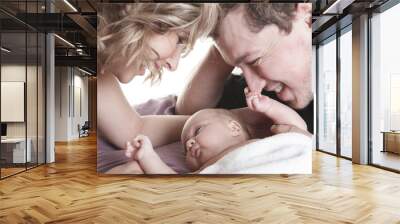 A beautiful couple with Baby on bed. Wall mural