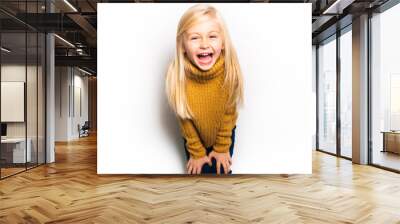 A Cute girl 5 year old posing in studio Wall mural