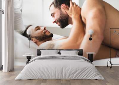 A Handsome gay men couple on bed together Wall mural