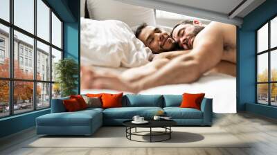 A Handsome gay men couple on bed together Wall mural