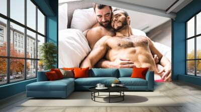 A Handsome gay men couple on bed together Wall mural