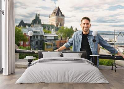 A nice tourist man with cheateau frontenac on the back Wall mural