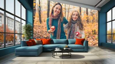 A portrait of a mother with child in the autumn park Wall mural