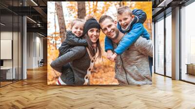 A portrait of a young family in the autumn park Wall mural