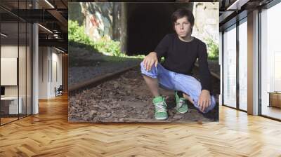 A young boy posing at the railroad Wall mural