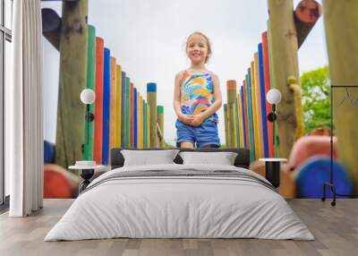 Active little girl having fun on playground Wall mural