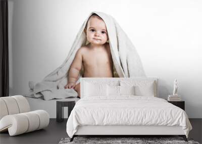 Baby boy portrait on white background with bath towel over his head Wall mural