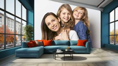 Beautiful young woman with two little cute daughter on white background. Wall mural