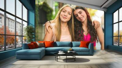 Best friends teen girl embracing each other with smiling Wall mural