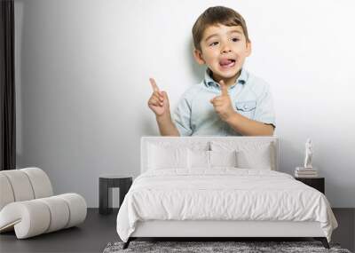 Boy having fun on studio grey background Wall mural