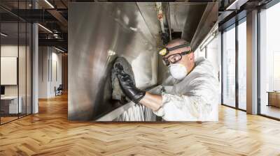 Commercial kitchen worker washing up at sink in professional kitchen Wall mural