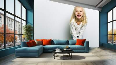 Cute girl 4-5 year old posing in studio Wall mural