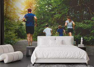 Family exercising and jogging together at an outdoor park Wall mural