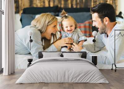 Family on bed with his baby on the morning Wall mural