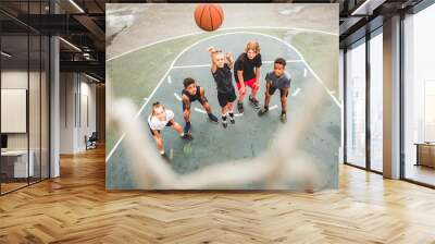 great child team in sportswear playing basketball game Wall mural