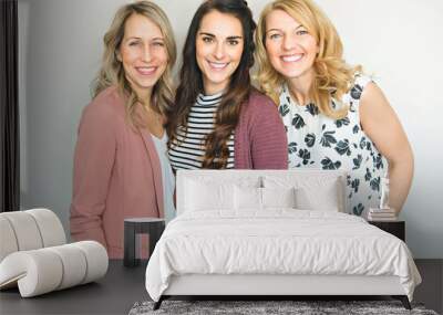 Group of friends woman portrait close to a white wall Wall mural