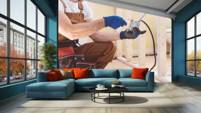 male electrician works working on a old house Wall mural