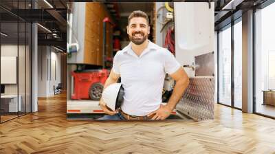 man with a hard hat standing in front of truck Wall mural